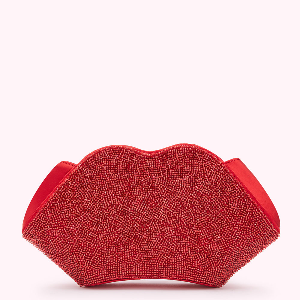 Red beaded lip-shaped clutch on a white background.