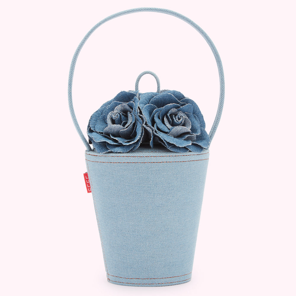 Light blue denim handbag shaped like a bucket with two denim roses on top and a top handle.