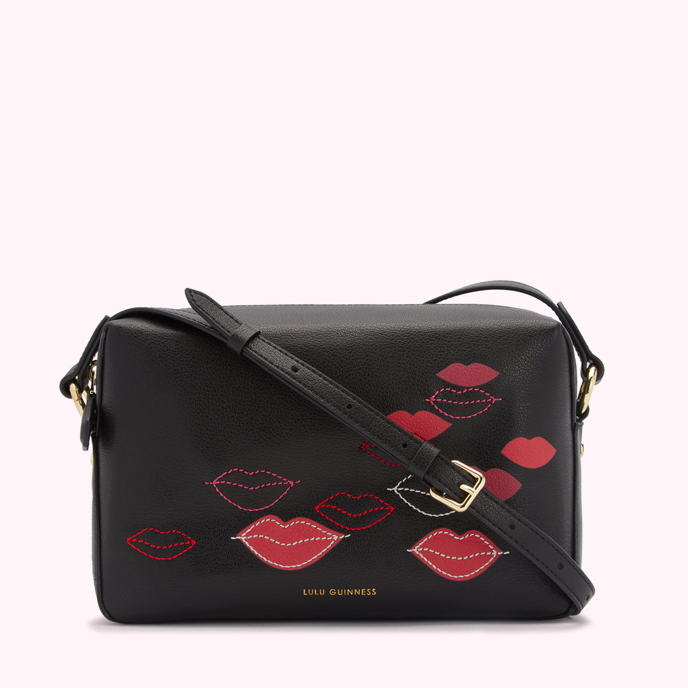 Black Lulu Guinness crossbody bag with red lips design.