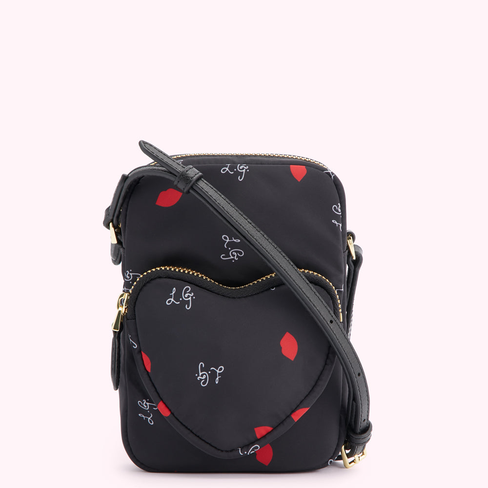 Black crossbody bag with a heart-shaped front pocket, featuring a repeating pattern of red lips and white "L.G." script on a black background.