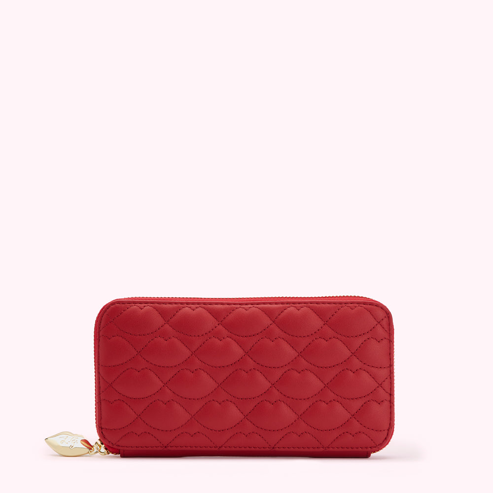 Red quilted zip-around wallet with lip-shaped pattern.