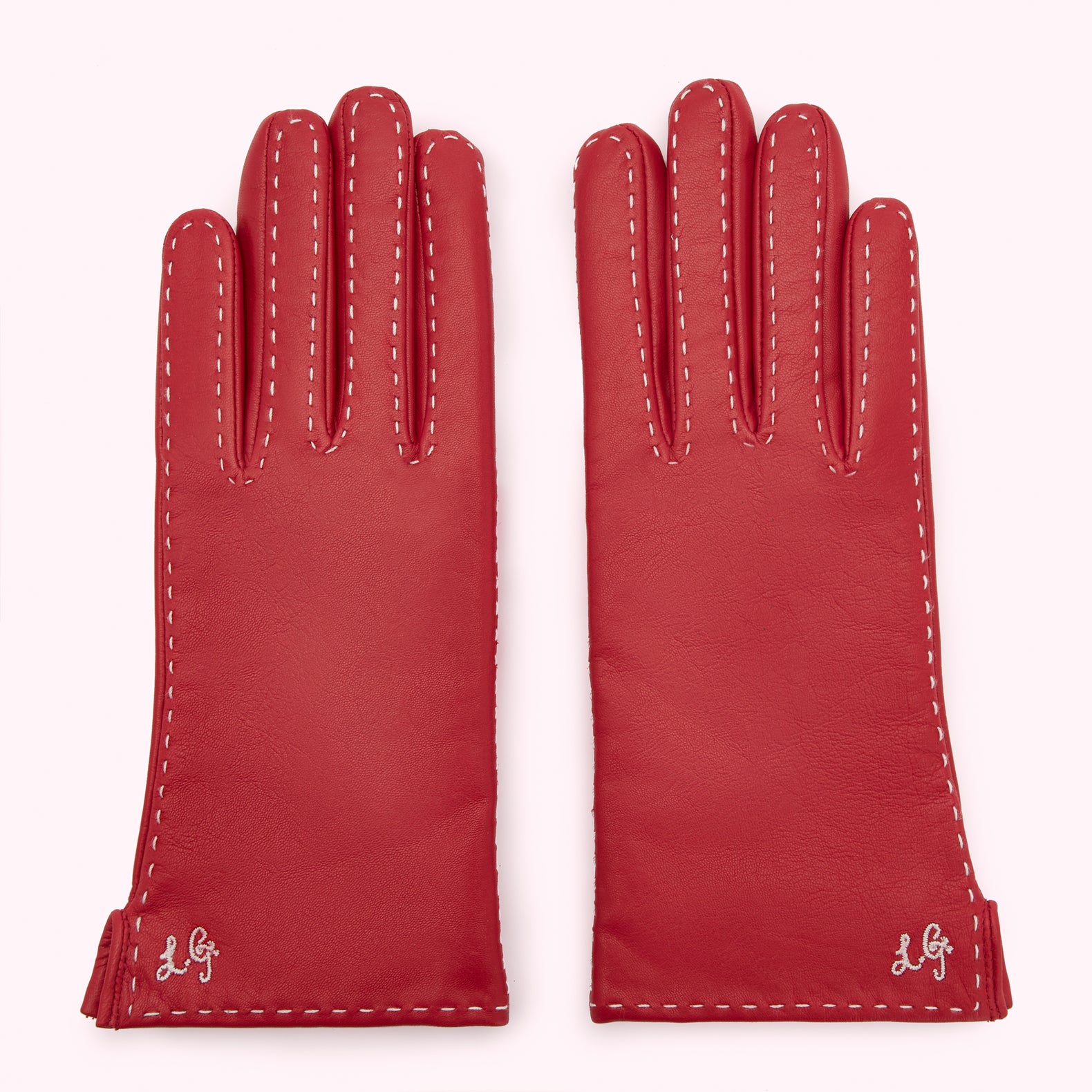 Pair of red leather gloves with white stitching and embroidered logo.