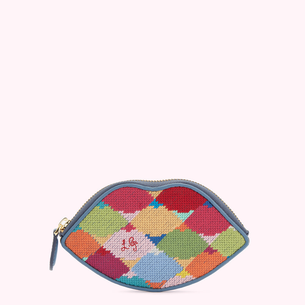 Multicolored needlepoint lip-shaped coin purse with a blue leather trim.