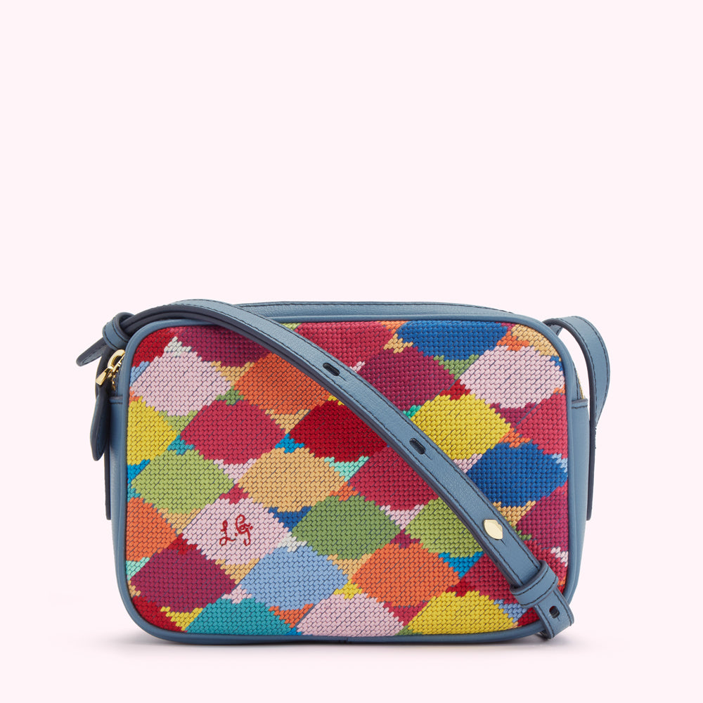 A small, rectangular crossbody bag with a blue leather strap and a colorful needlepoint front.