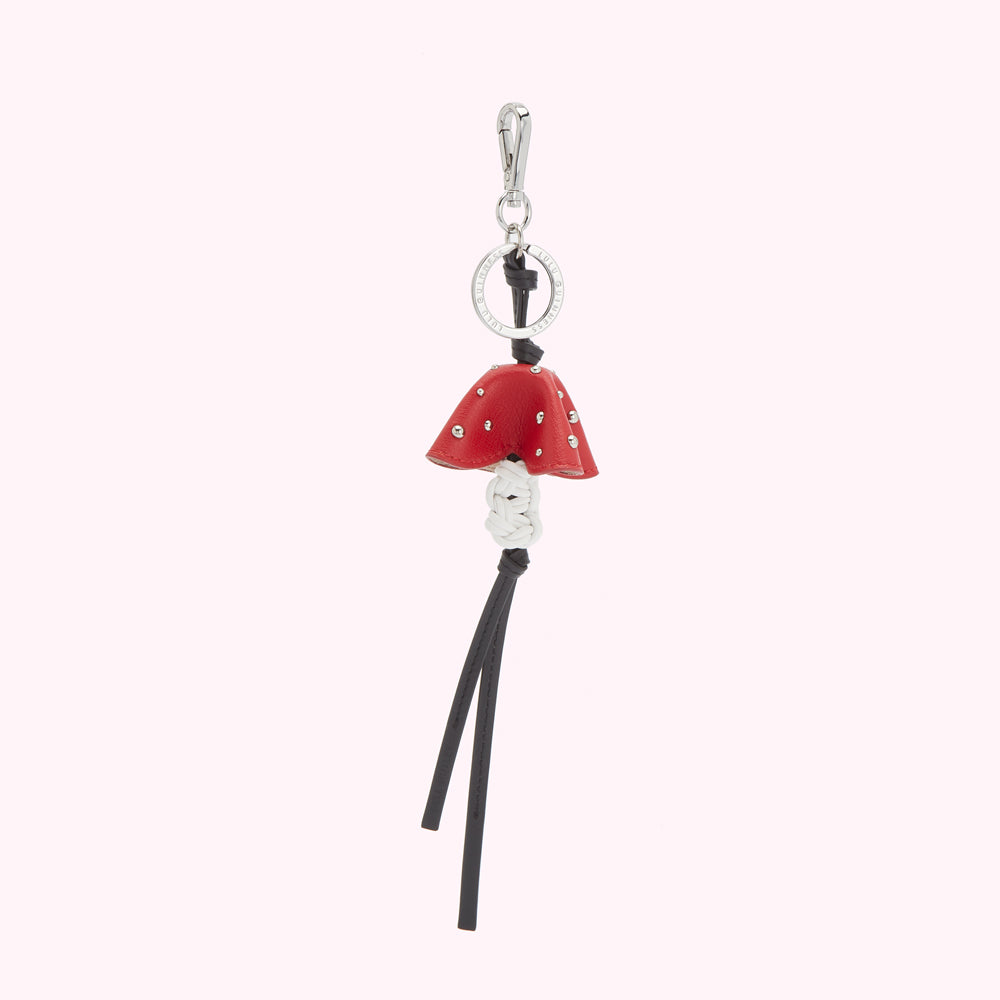 Red leather mushroom-shaped keychain with silver-toned metal details and black leather tassels.