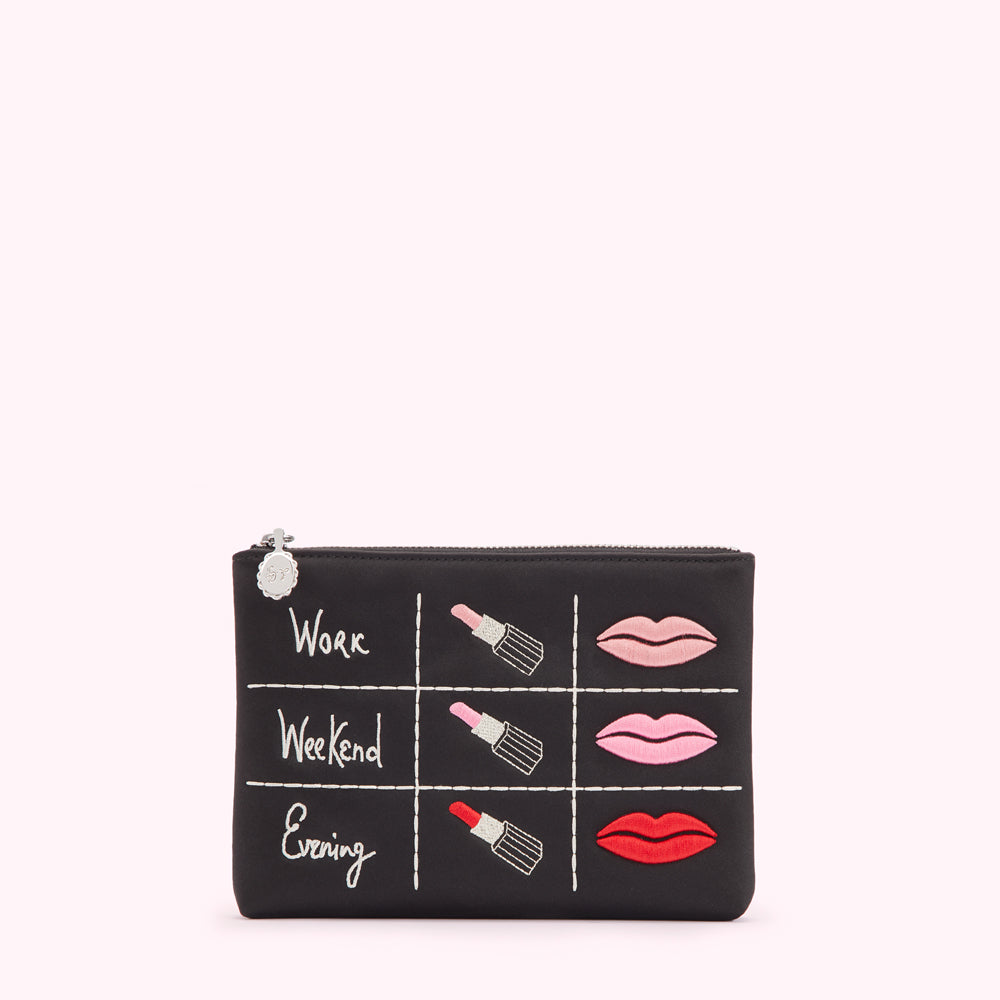 Black makeup bag with embroidered lipsticks and lips, categorized for work, weekend and evening.