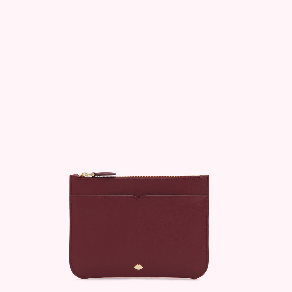 Burgundy leather zip pouch on white background.