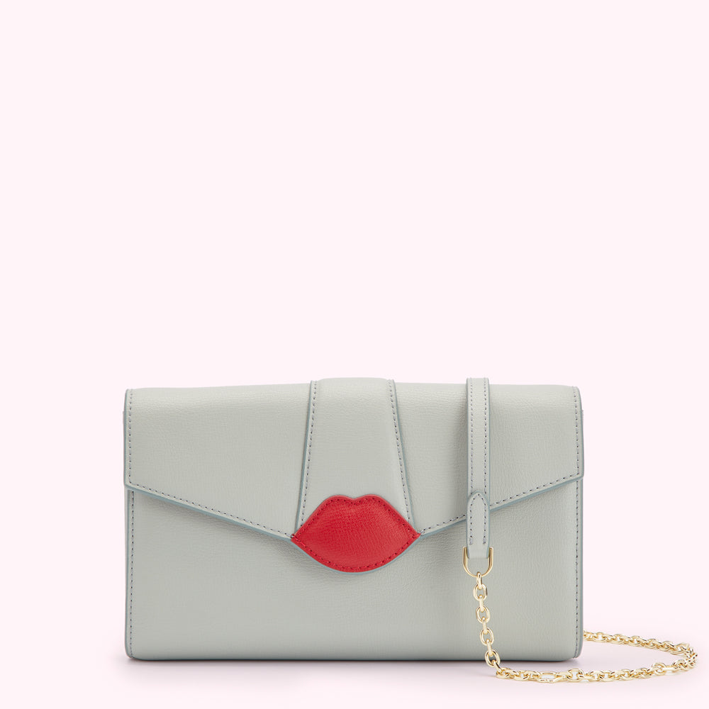 Light grey leather clutch with red lip detail and gold chain strap.