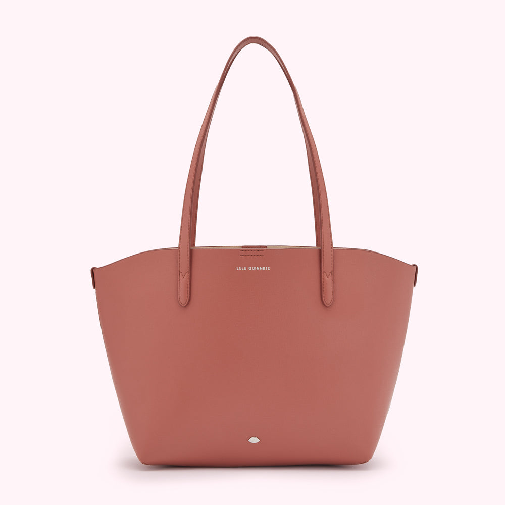 Dusty rose Lulu Guinness tote bag on a white background.