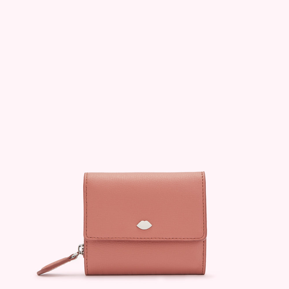 Dusty rose leather wallet with a silver lip emblem.