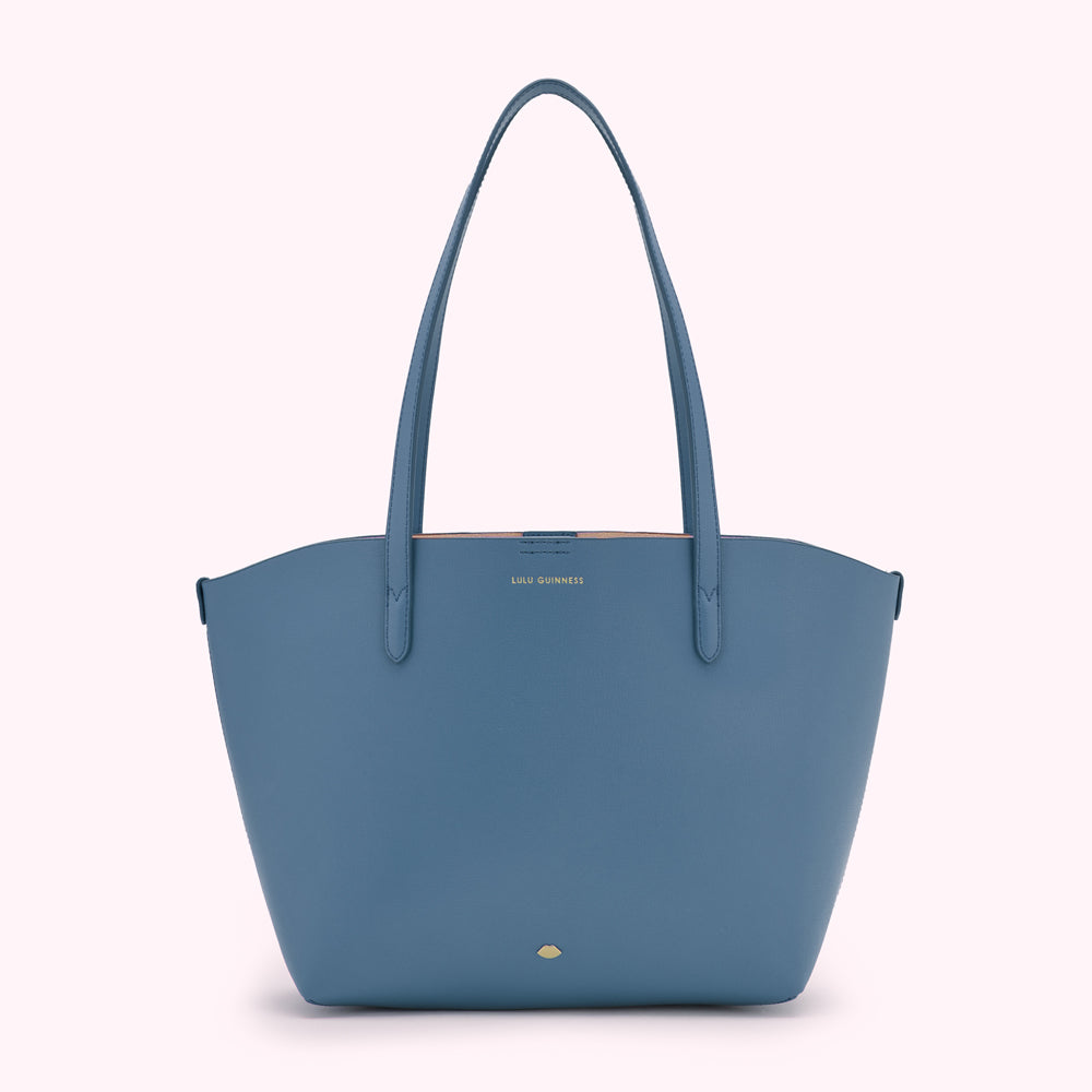 A blue Lulu Guinness tote bag on a white background.