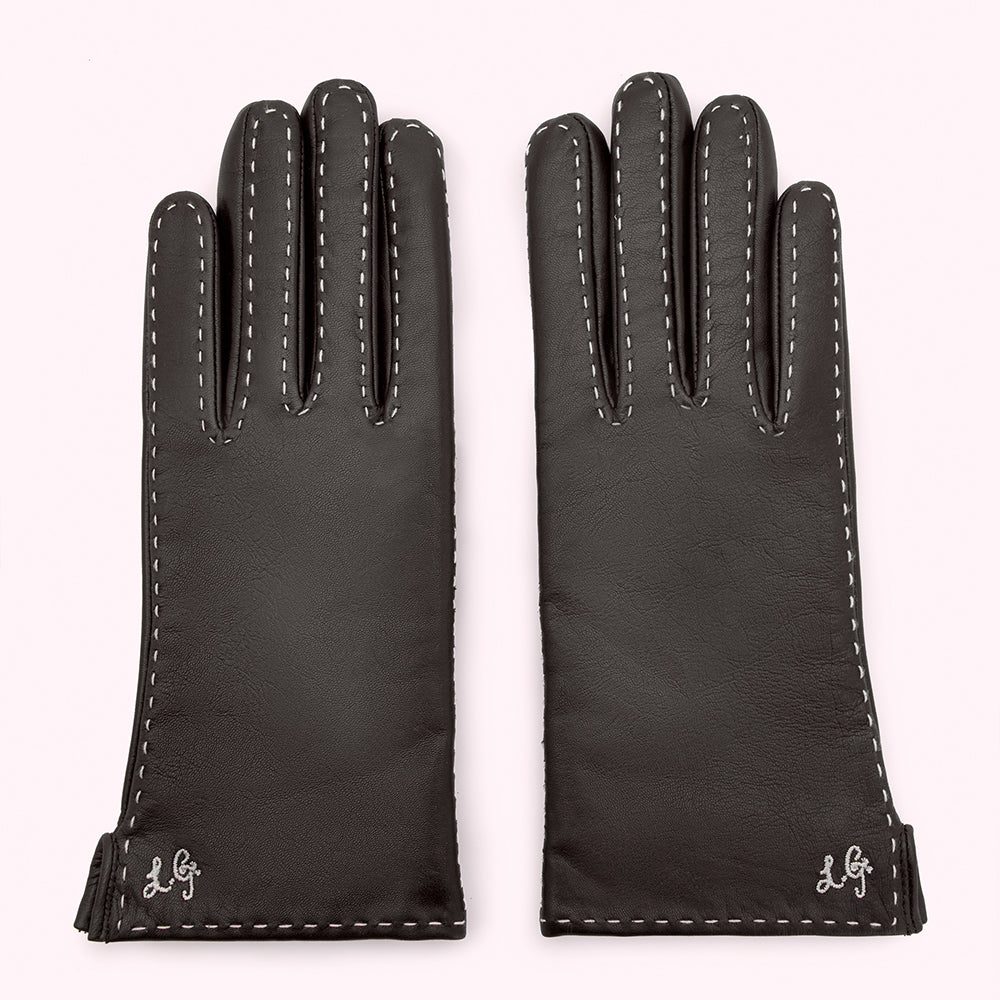 Pair of black leather gloves with white stitching and embroidered logo on a white background.