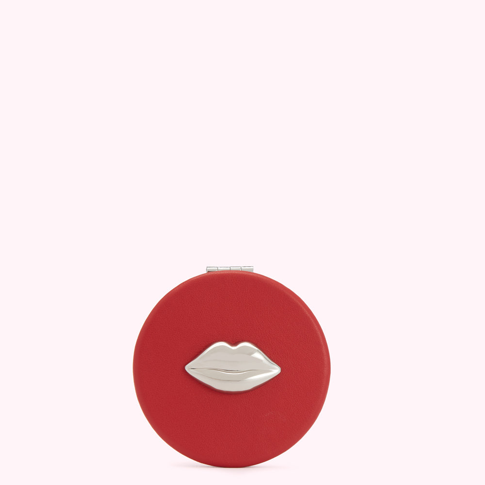 Red compact mirror with silver lip design.