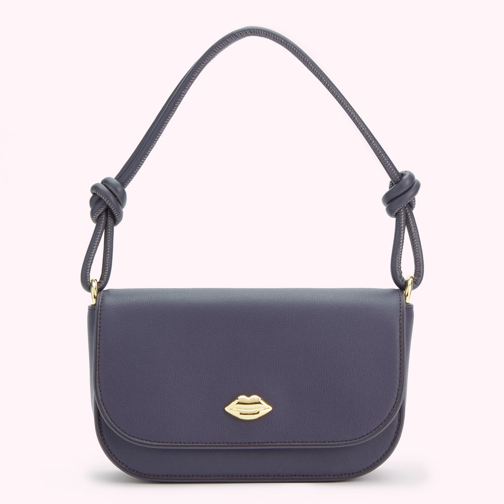 A dark gray shoulder bag with a knotted strap and a gold lip-shaped clasp.