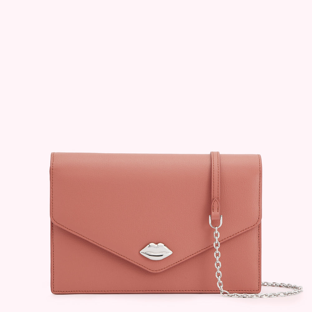 Dusty rose leather clutch with silver lip-shaped clasp and detachable chain strap.