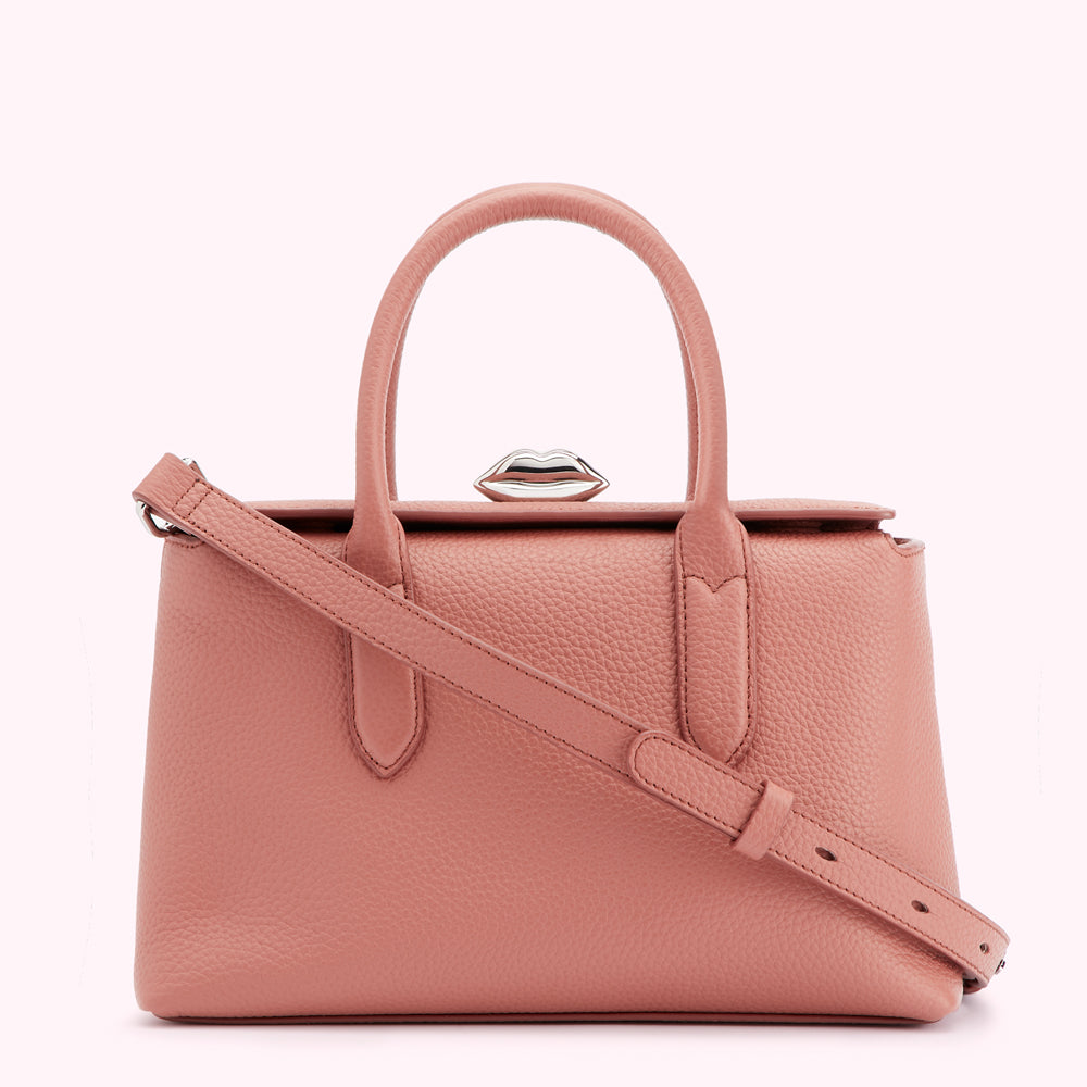 A dusty rose-colored leather handbag with a silver lip-shaped clasp.