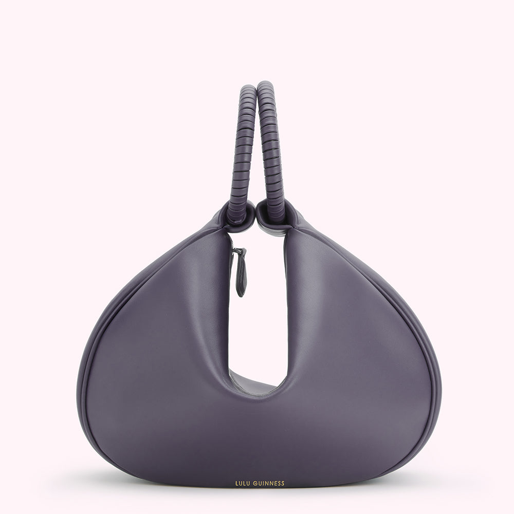 Purple Lulu Guinness handbag with a unique curved shape and twisted top handles.