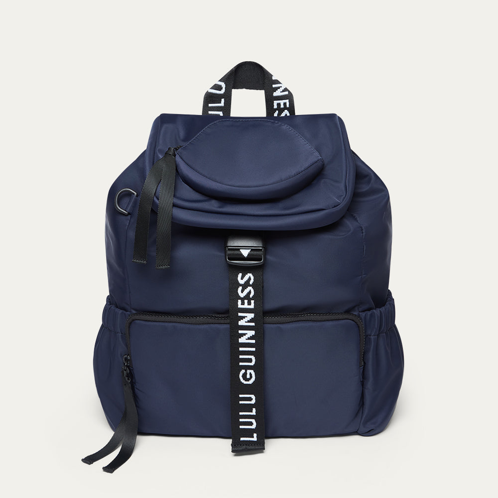 Navy blue backpack with 'Lulu Guinness' branding on a white background