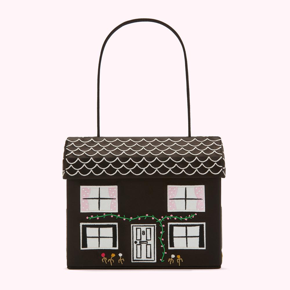 Black house-shaped handbag with embroidered details.