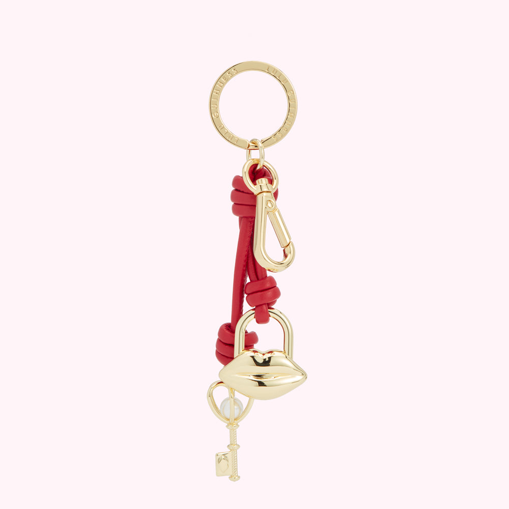 Red leather keyring with gold-toned lip-shaped padlock and key charm.
