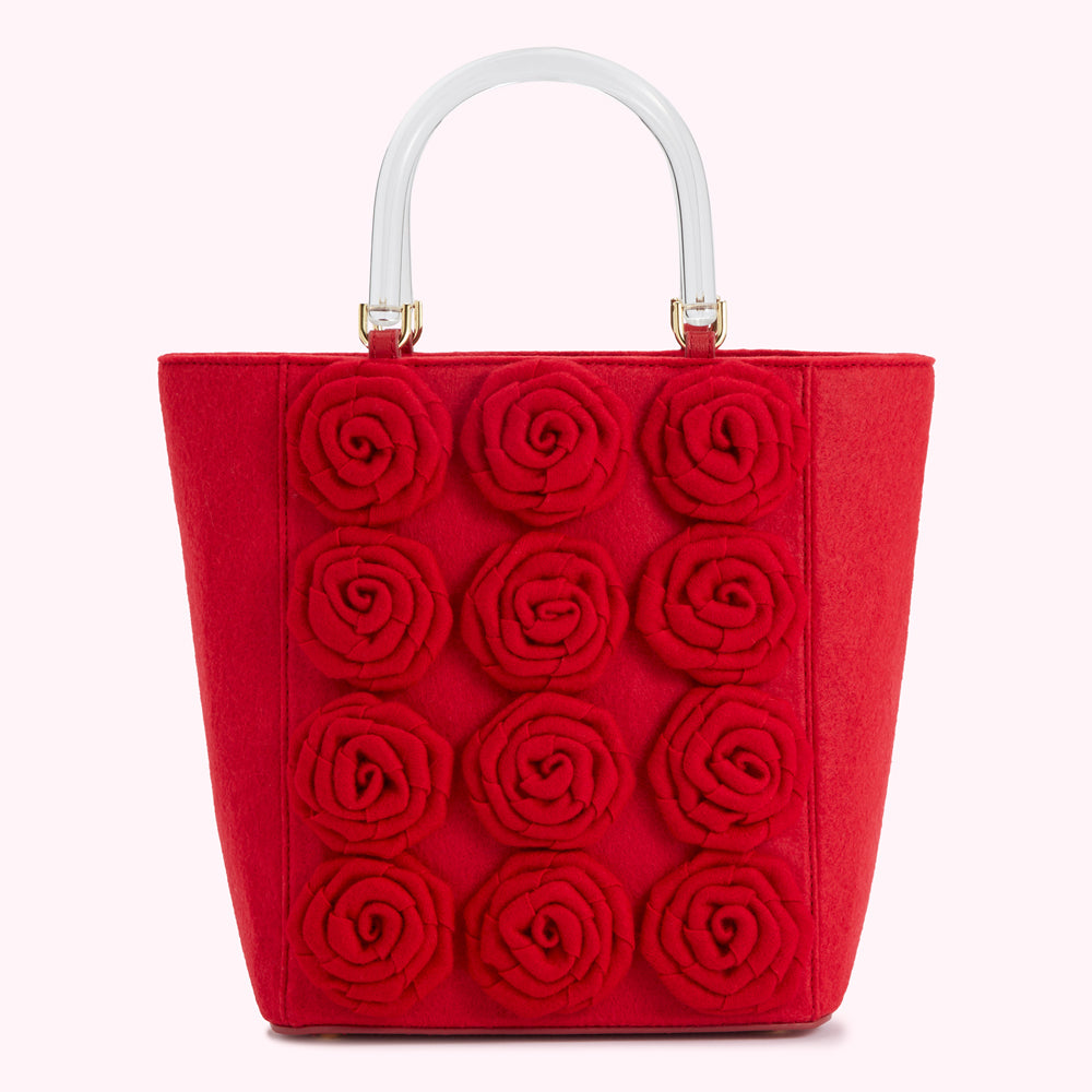 Red felt tote bag with clear handles and red felt rose appliqué.