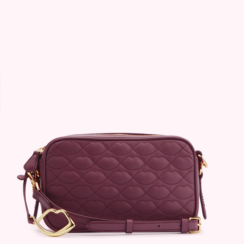 Burgundy quilted crossbody bag with gold-toned heart-shaped clasp.