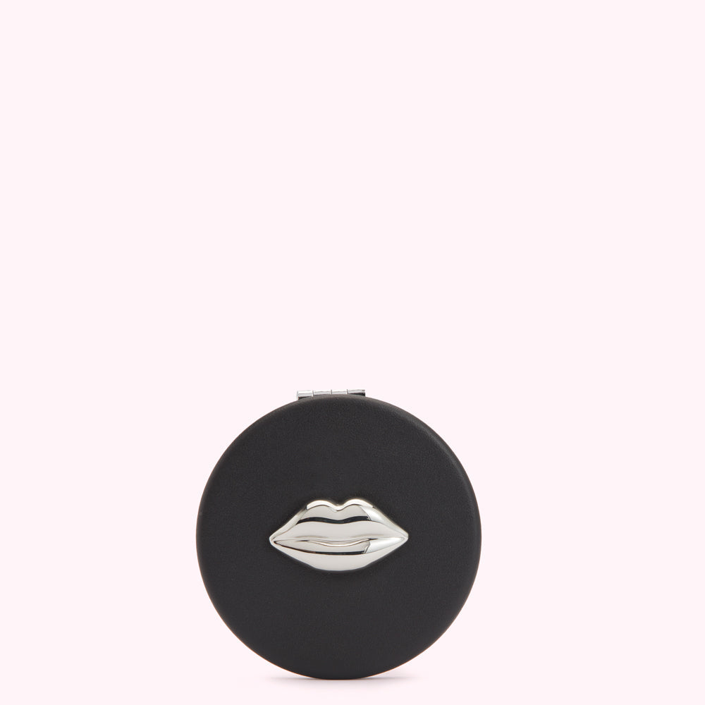 Black round compact mirror with silver lip design.