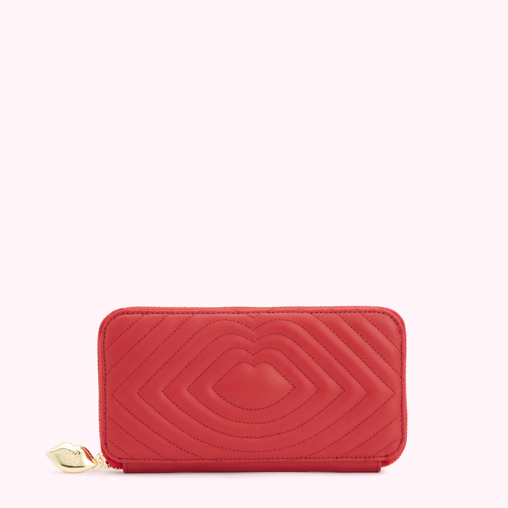 Red quilted zip-around wallet with lip-shaped pattern and gold charm.
