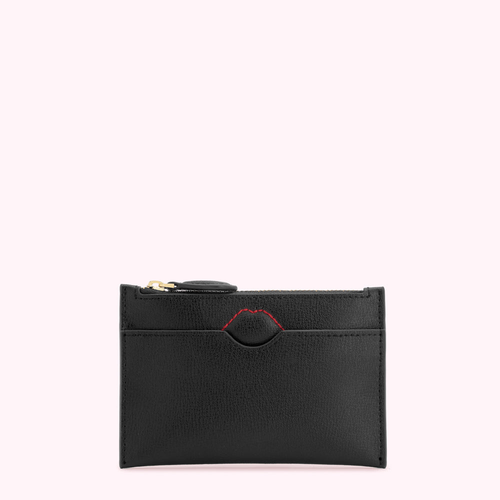 Black leather cardholder with a gold zipper and red lip detail.