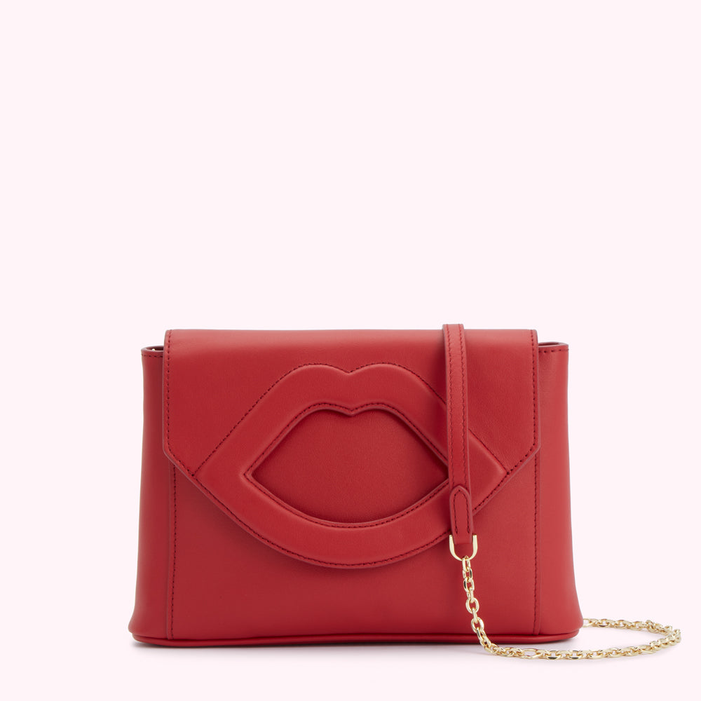 Red leather clutch with lip-shaped cutout detail and gold chain strap.