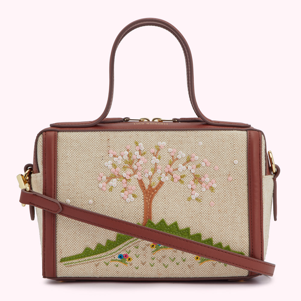 Beige Lulu Guinness handbag with brown leather trim and an embroidered floral design.