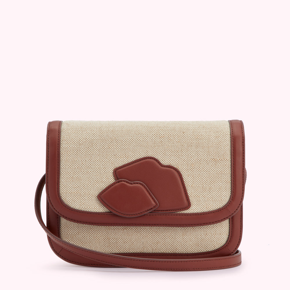 Beige canvas crossbody bag with brown leather accents and lip-shaped details.