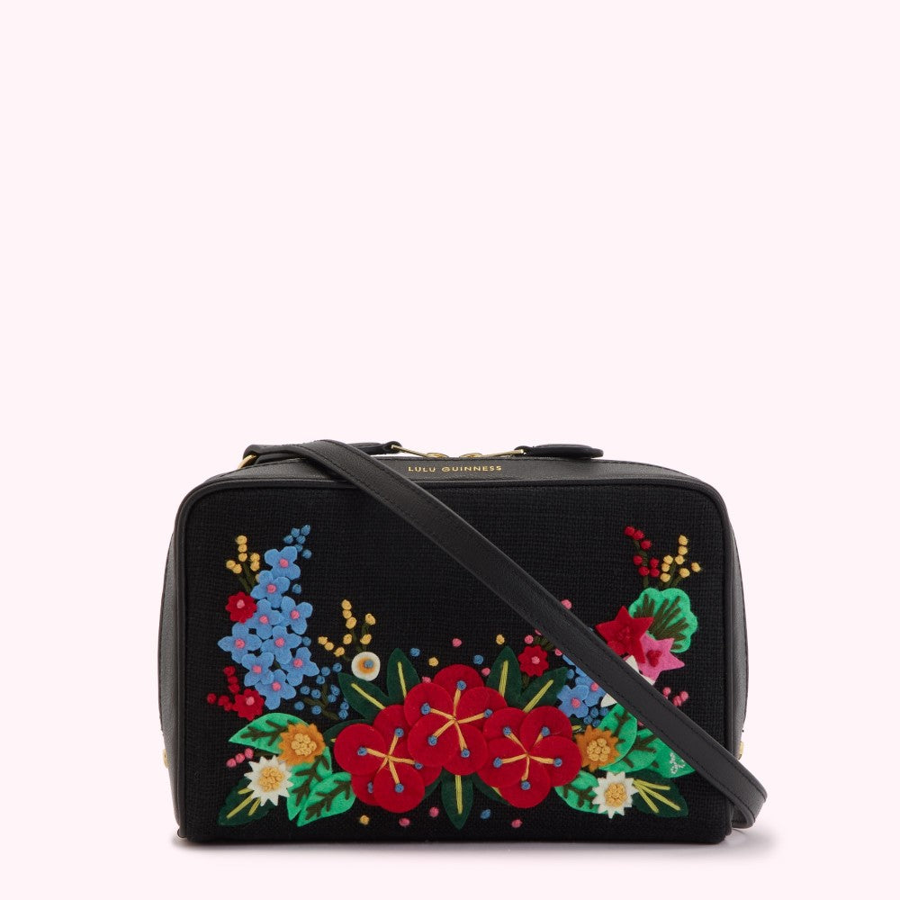 Black crossbody bag with colorful embroidered flowers.