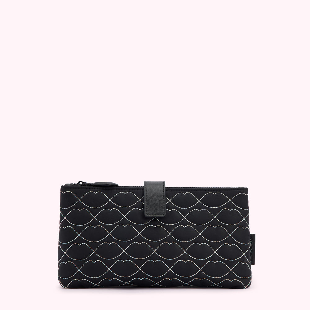 Black quilted makeup bag with a repeating lip pattern.