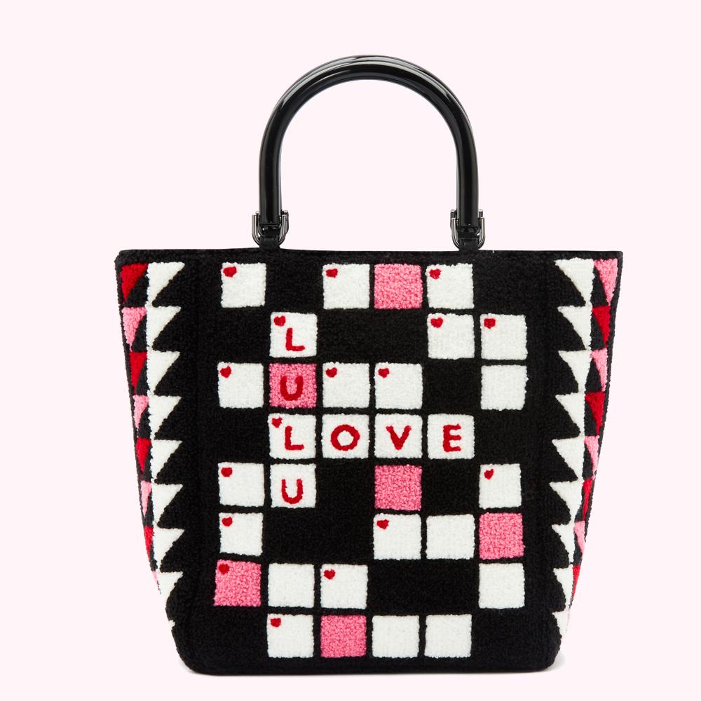 Black and white crossword-style tote bag with pink accents and red "LOVE LULU" lettering against a white background.