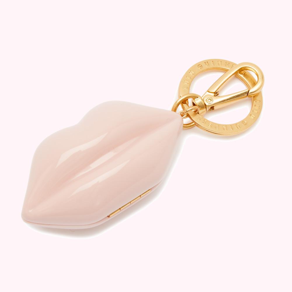 Pink lip-shaped keychain with gold-colored clasp and Lulu Guinness branding.