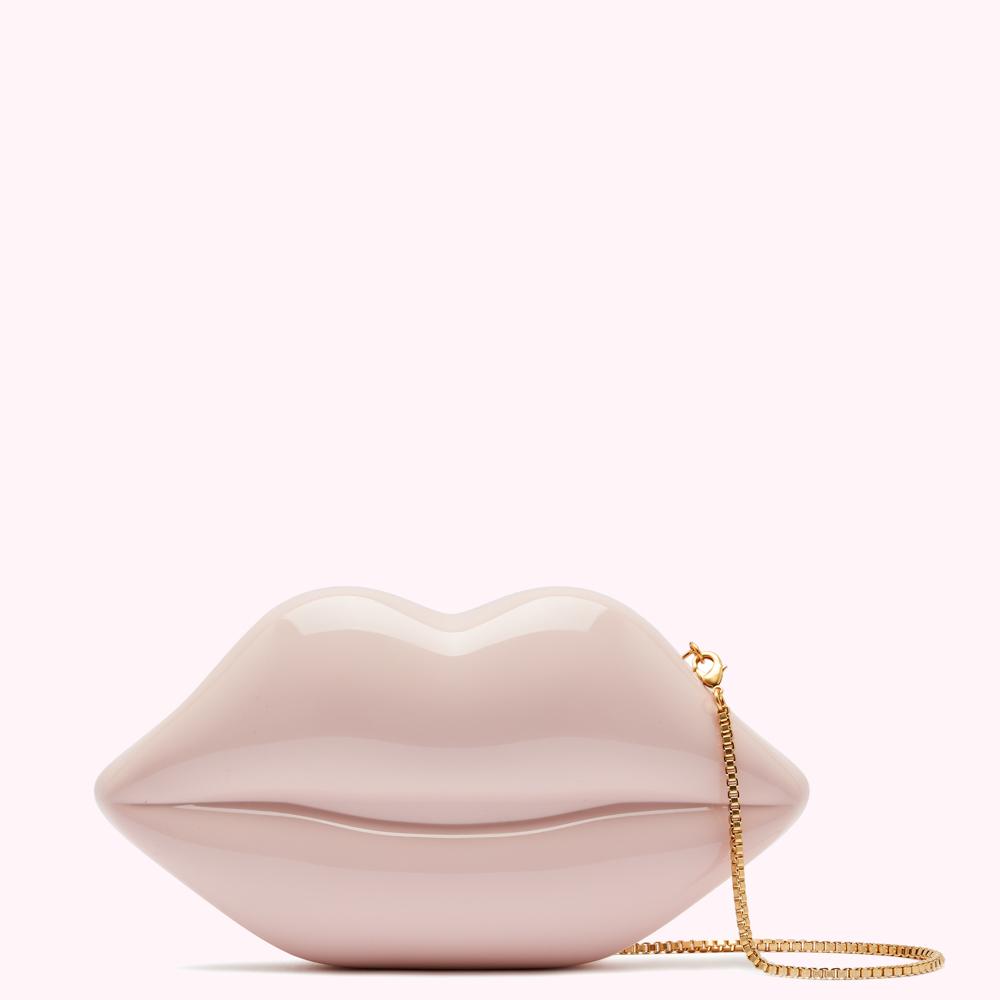 Glossy pale pink lip-shaped clutch with a gold chain strap, displayed against a light pink background