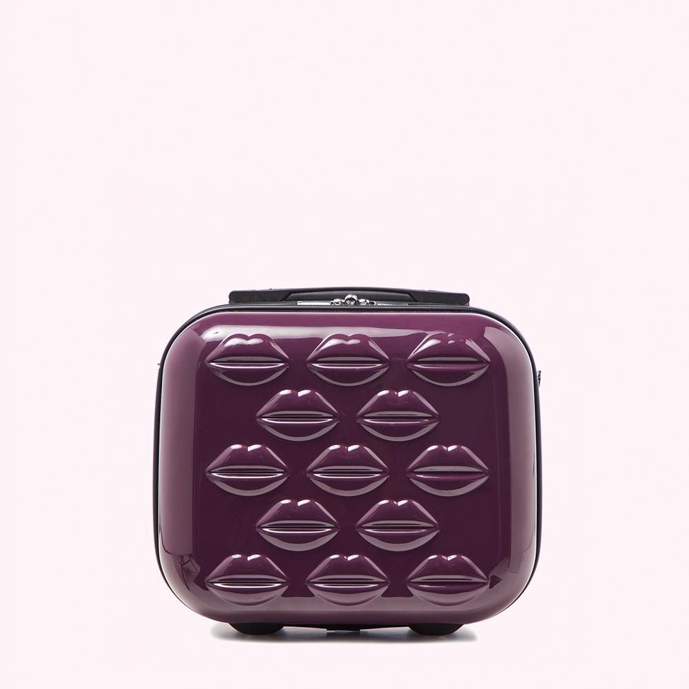 Purple carry-on suitcase with lip-shaped embellishments.