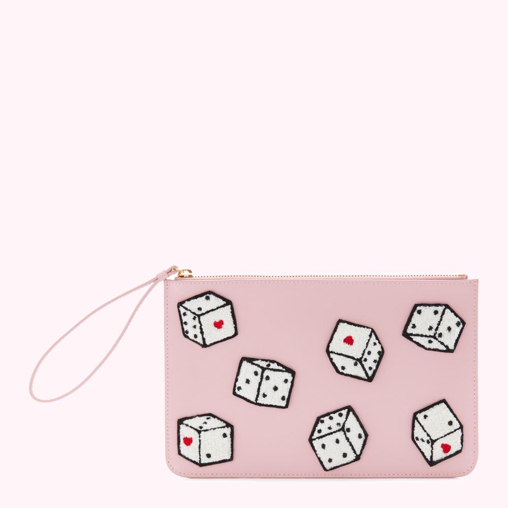Pink leather clutch with embroidered dice.