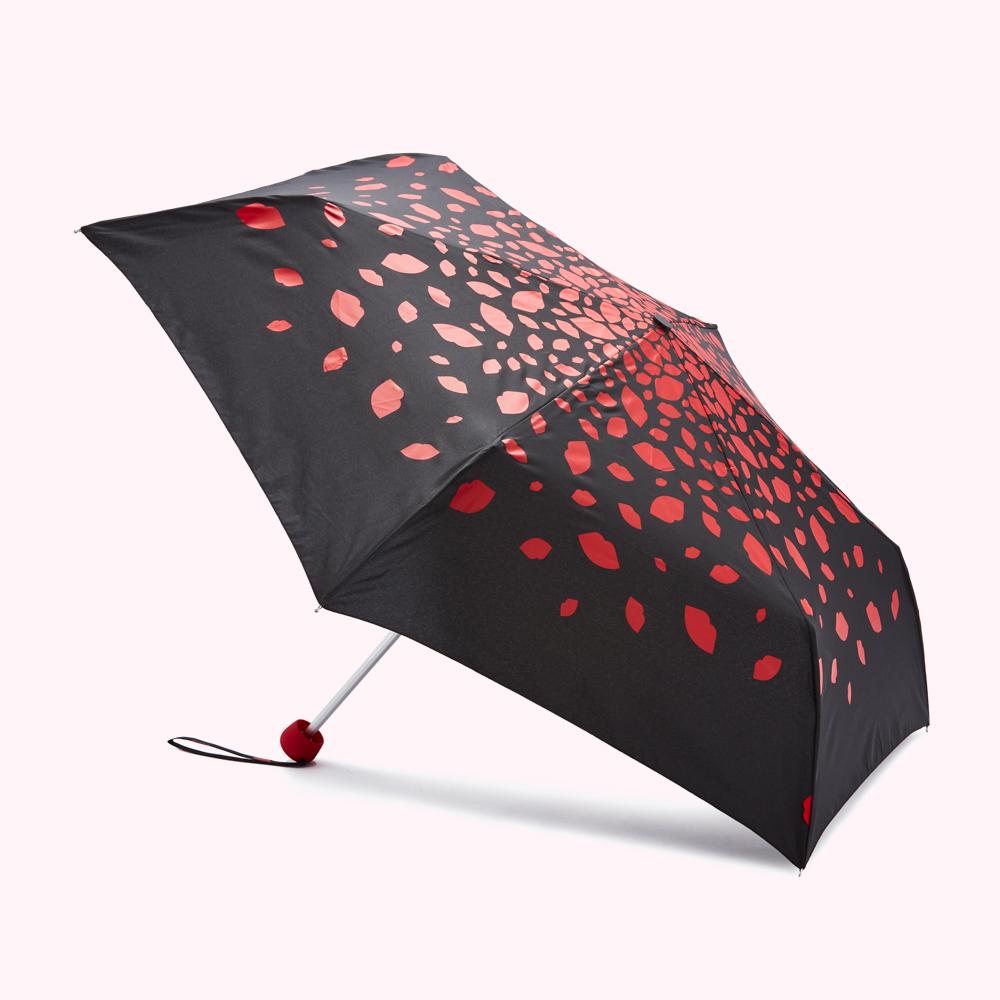 Compact black umbrella with a red lip print.