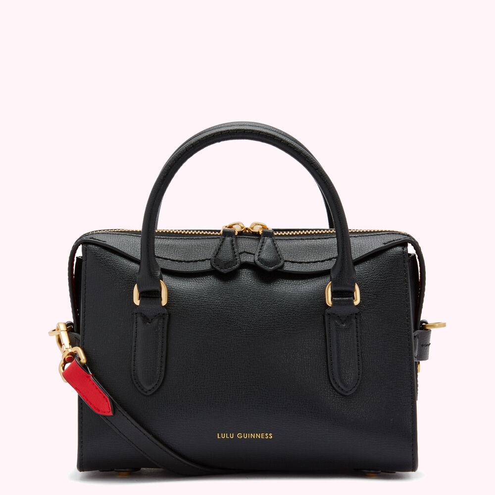 Black Lulu Guinness leather satchel with gold hardware and a red and black strap.