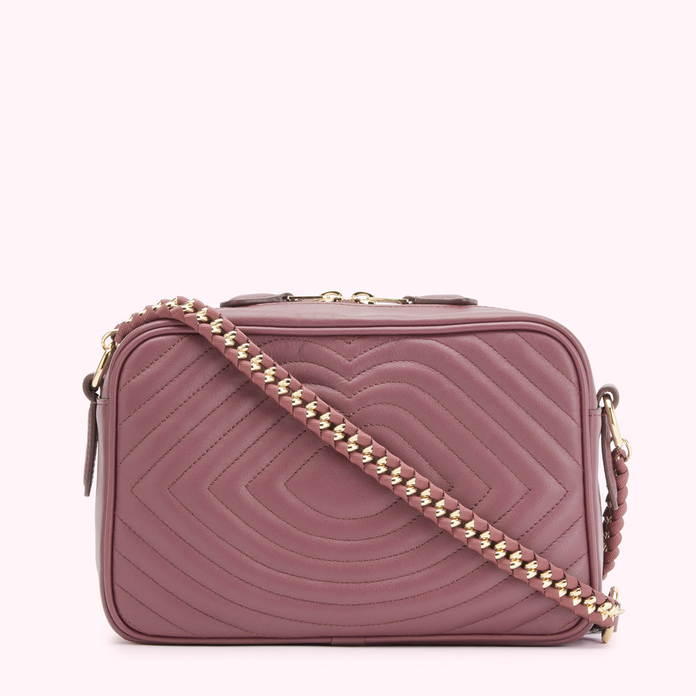 A mauve quilted leather crossbody bag with a gold chain strap.