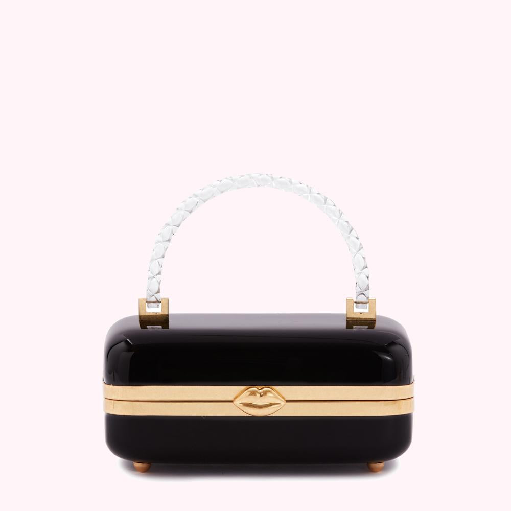 Black rectangular box handbag with a clear handle and gold lip detail.