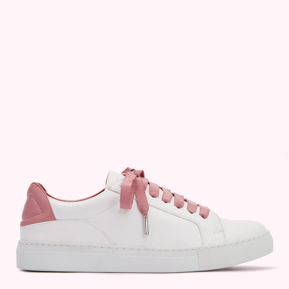 White leather sneaker with dusty rose laces and heel detail on a white background.