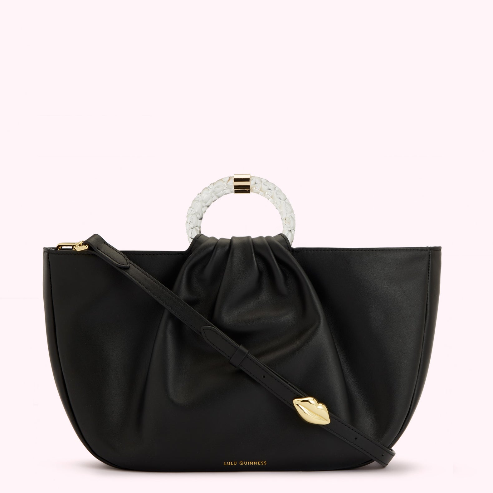 Black leather Lulu Guinness tote bag with a clear Perspex handle and gold lip detail.