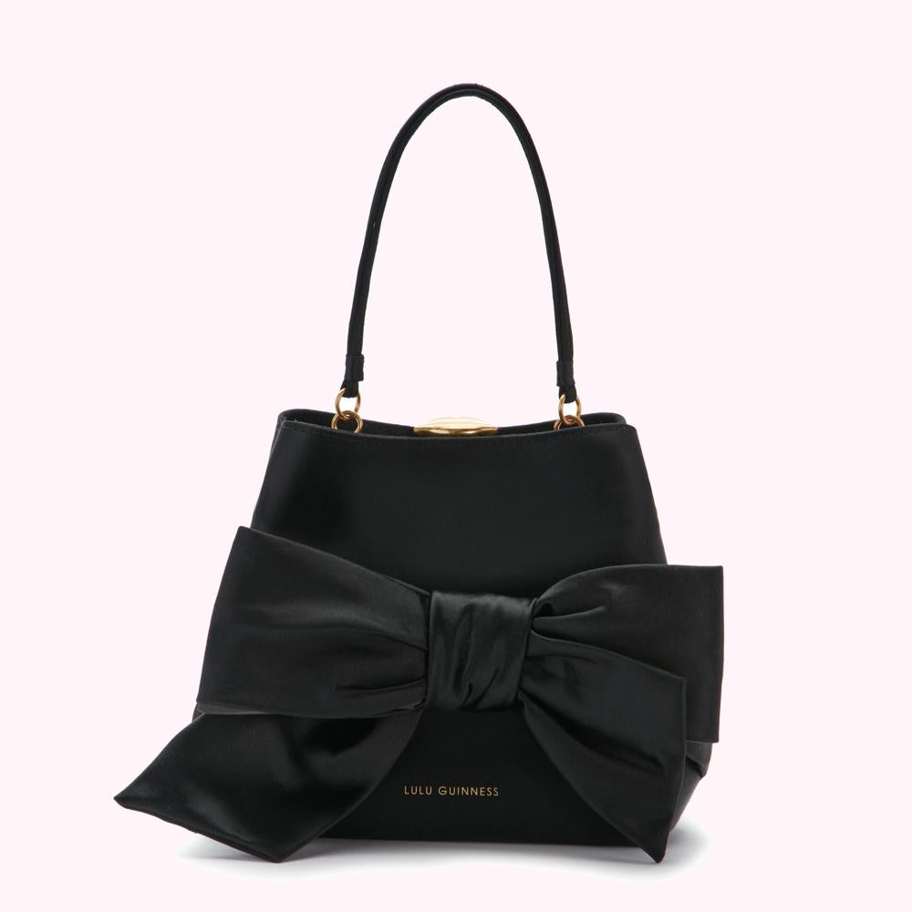 Black Lulu Guinness satchel bag with large black satin bow.