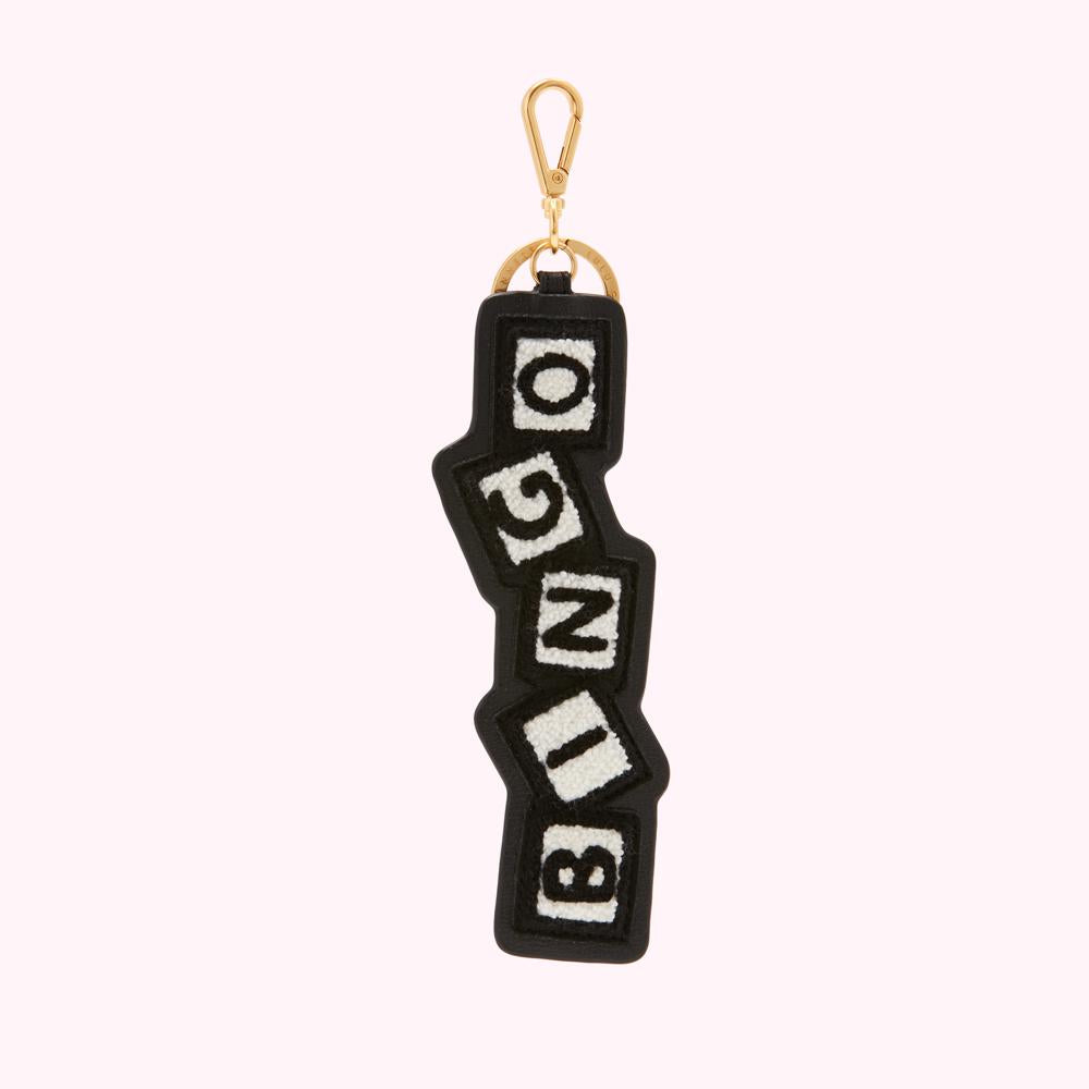 Black leather key chain with gold colored clasp featuring the word BINGO in off-white lettering on black square blocks.