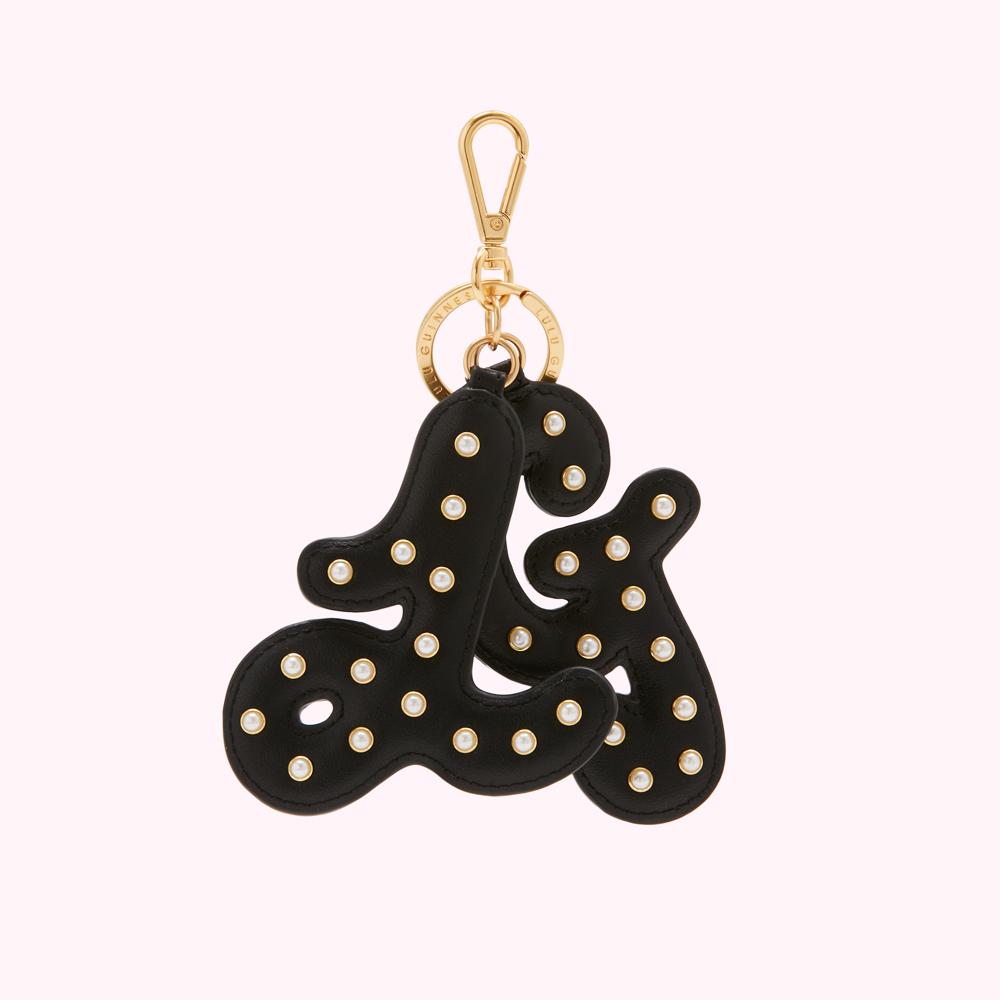 Black leather keychain with gold lettering and pearl accents spelling out "LG".