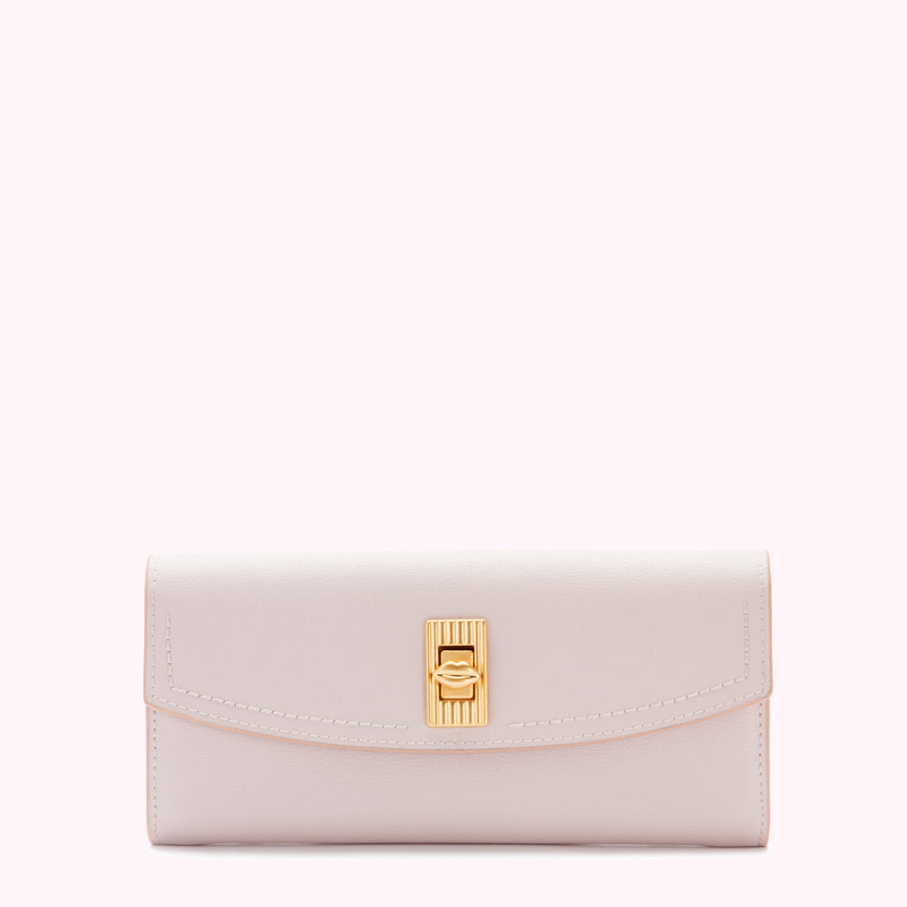Pale pink leather wallet with gold clasp against a white background.