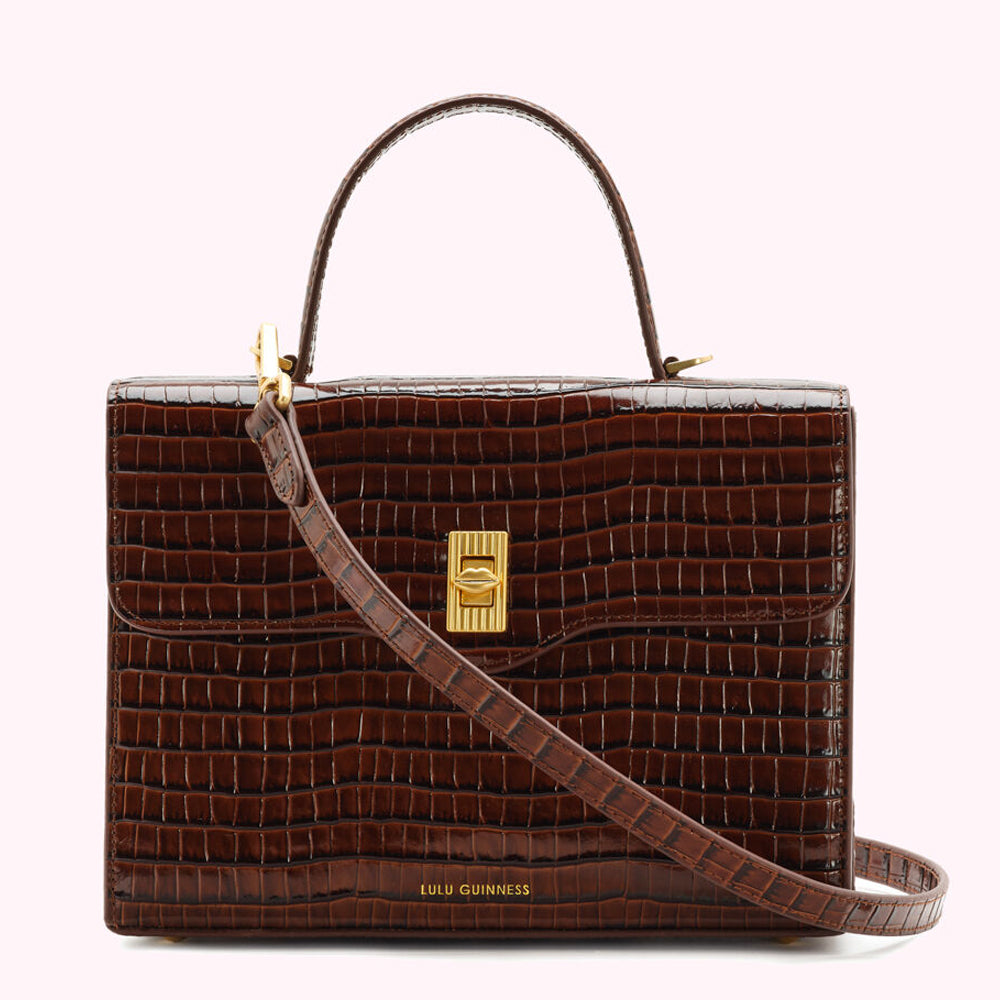 Brown Lulu Guinness crocodile-embossed leather handbag with gold hardware and adjustable strap.